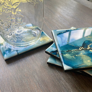 Blue and gold coasters on gray table 