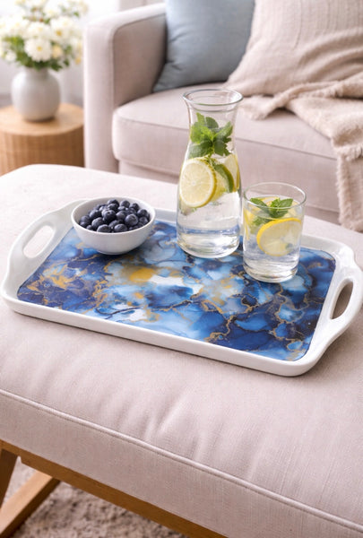 Hand painted ceramic handle tray with blue alcohol ink design, styled with a carafe and glasses