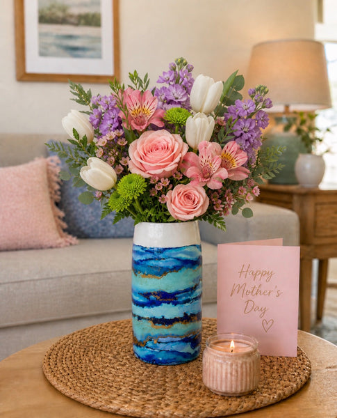 Blue hand-painted cylinder vase with flowers